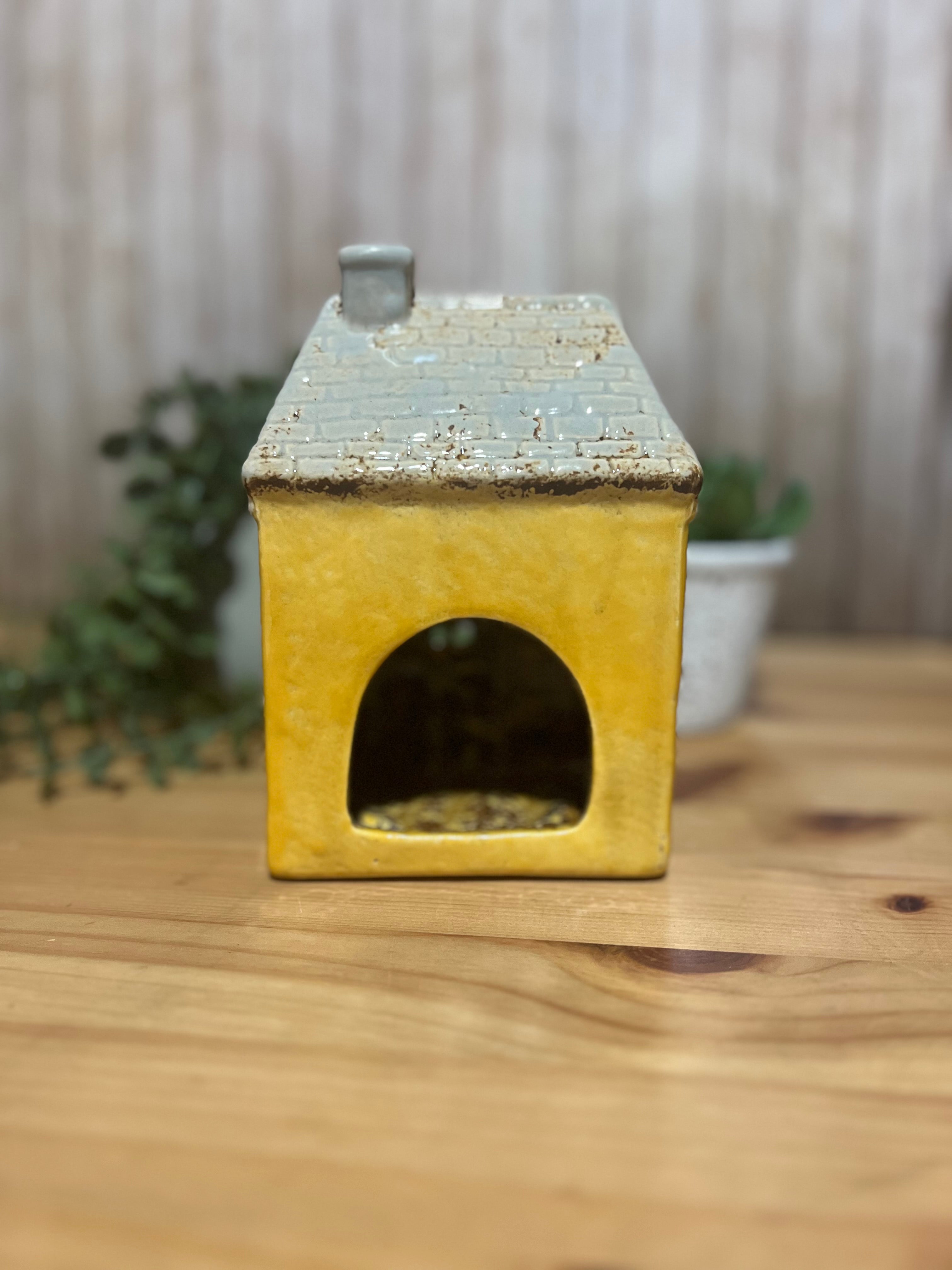 Tall Yellow House with Brown Door and Pot Plants Out Front Roof Loft Windows