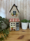 Tall Glazed Ceramic House with Bench, Pot Plants and Awning